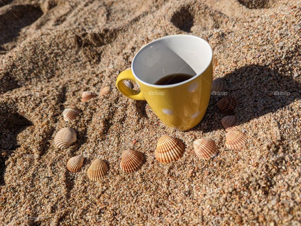 Polka dot cups on the beach