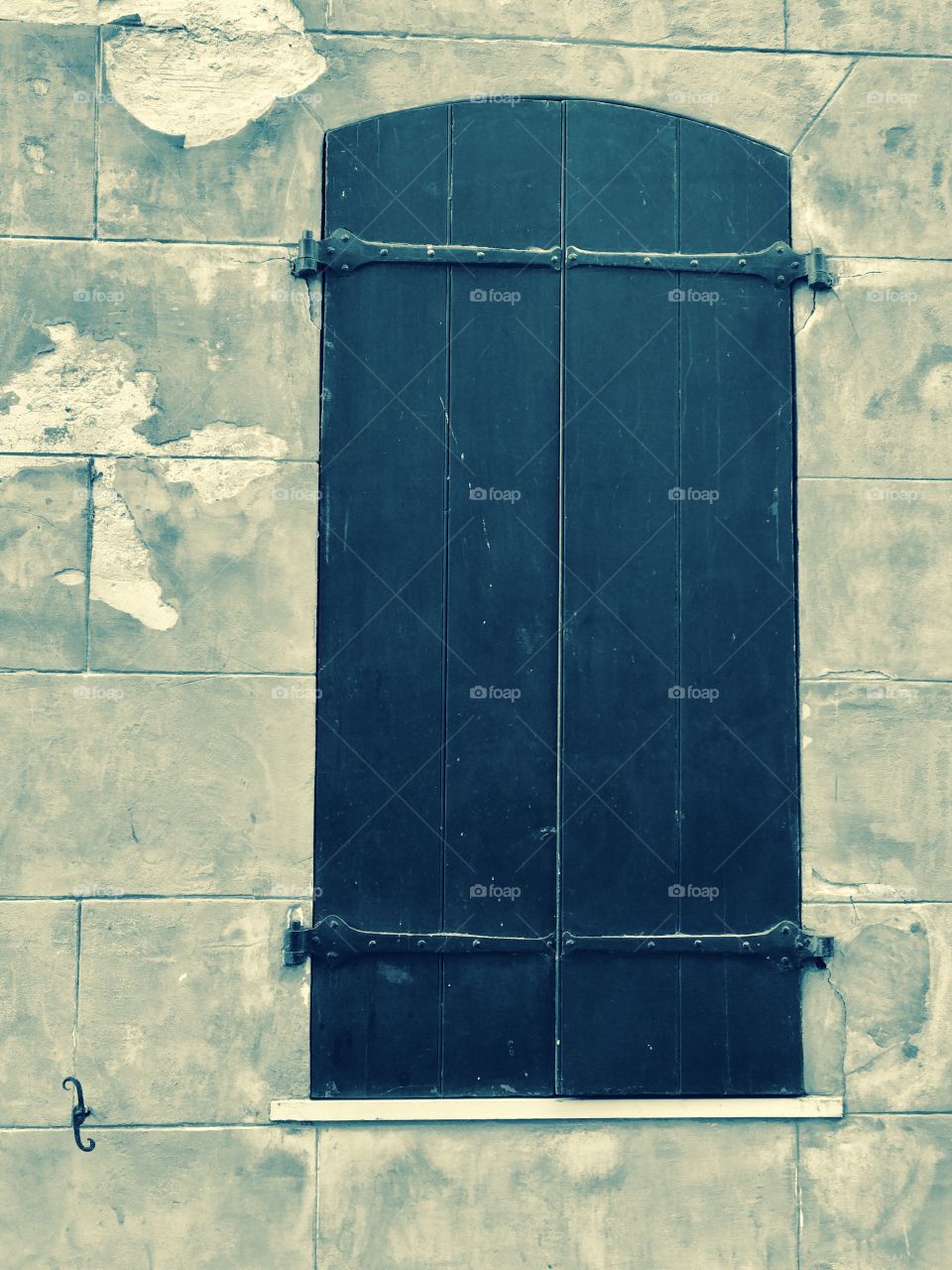Old wooden shutters on old cement wall. 