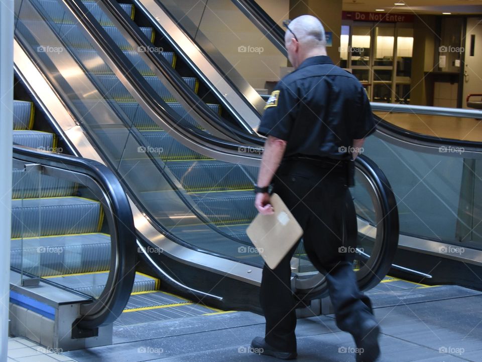 Airport worker carrying an envelope at the airport 