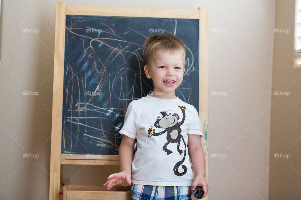 Toddler in front of blackboard 