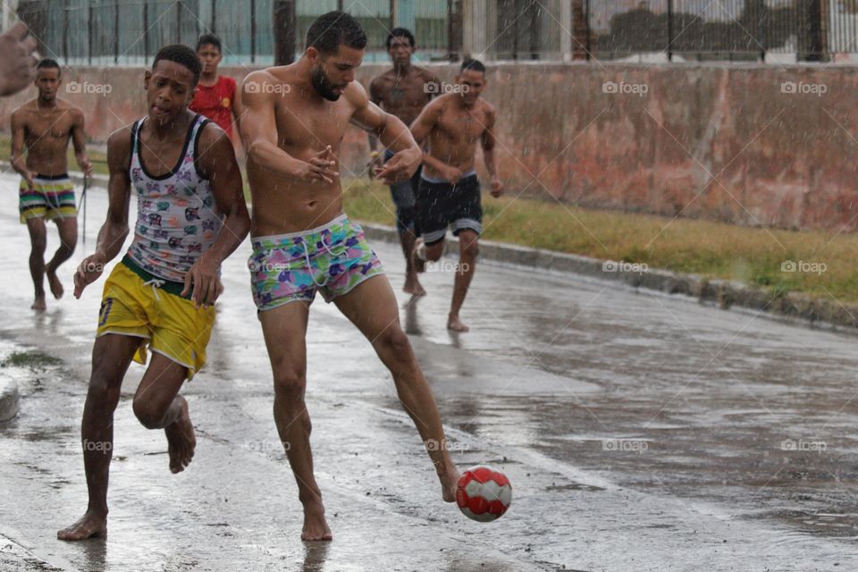 Group of people playing football on street