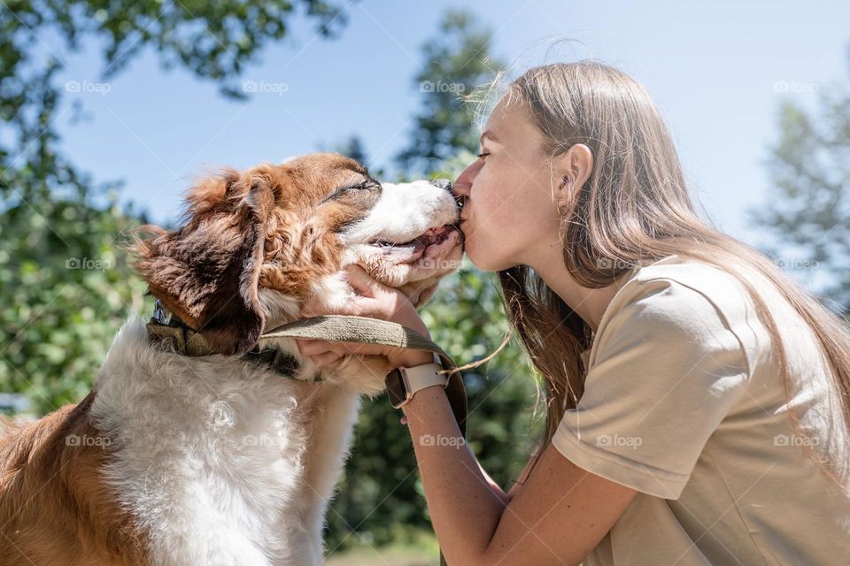 woman kissing her dog