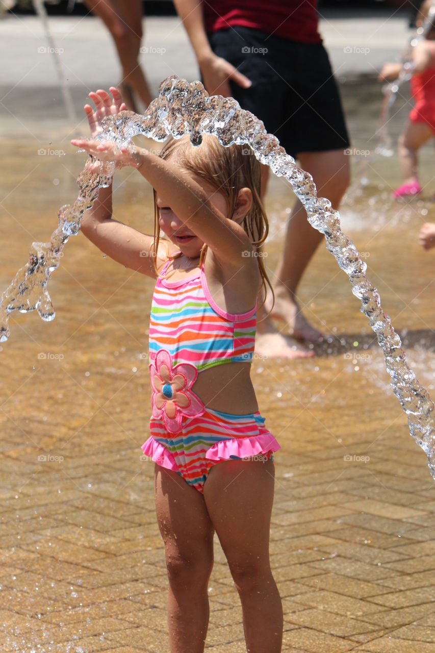 Little girl playing at a water park