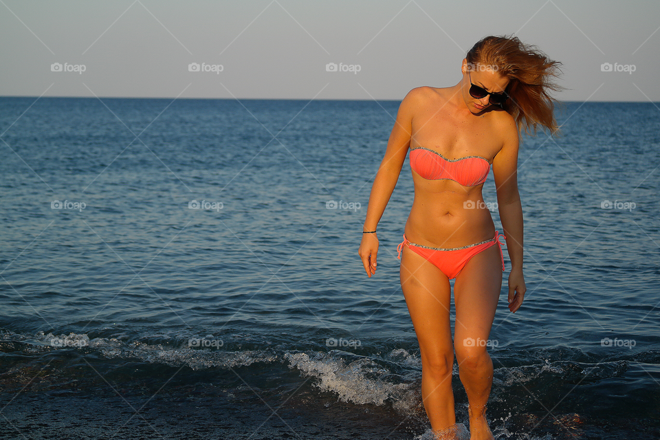 Woman in bikini standing in water