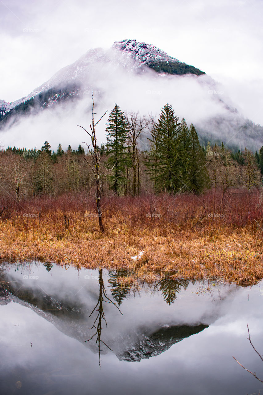 Reflecting on the beauty of the cascade mountain range in Washington state. Reflection in the water. 