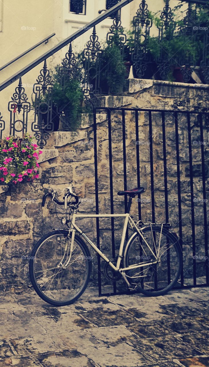 bicycle and flowers. old stone house. amazing architecture. vintage
