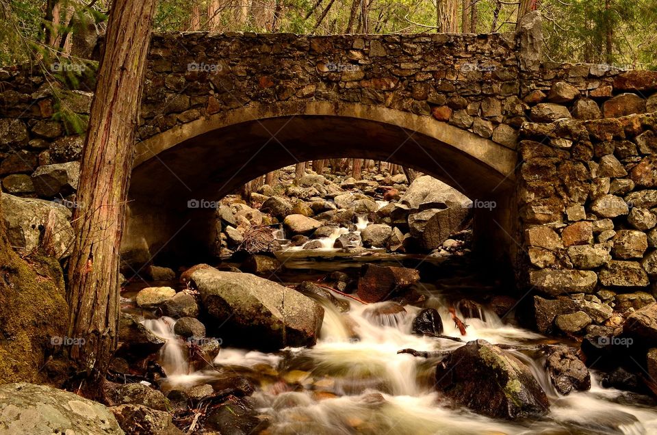 Flowing river under a bridge