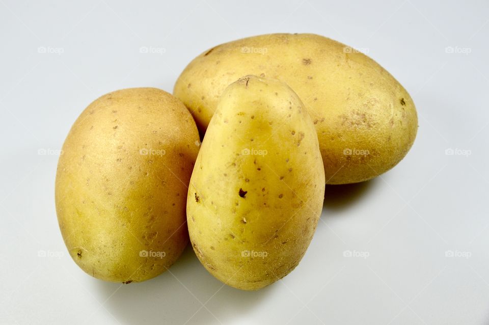 the potato over the white background 