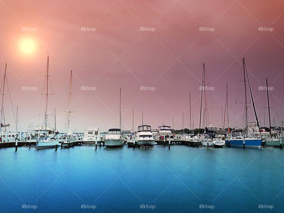 A serene scene of boats moored at the marina.