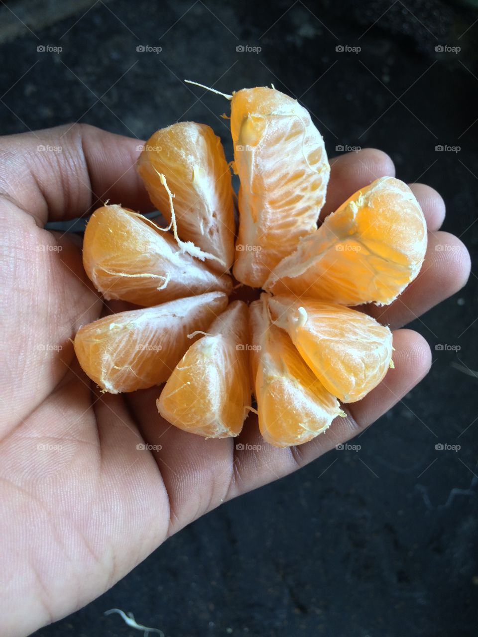 Close-up of a person's hands holding an orange