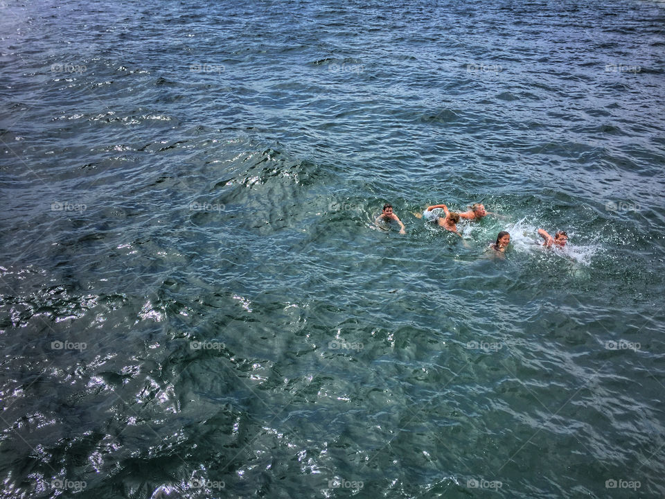 Group of people swimming in the open ocean