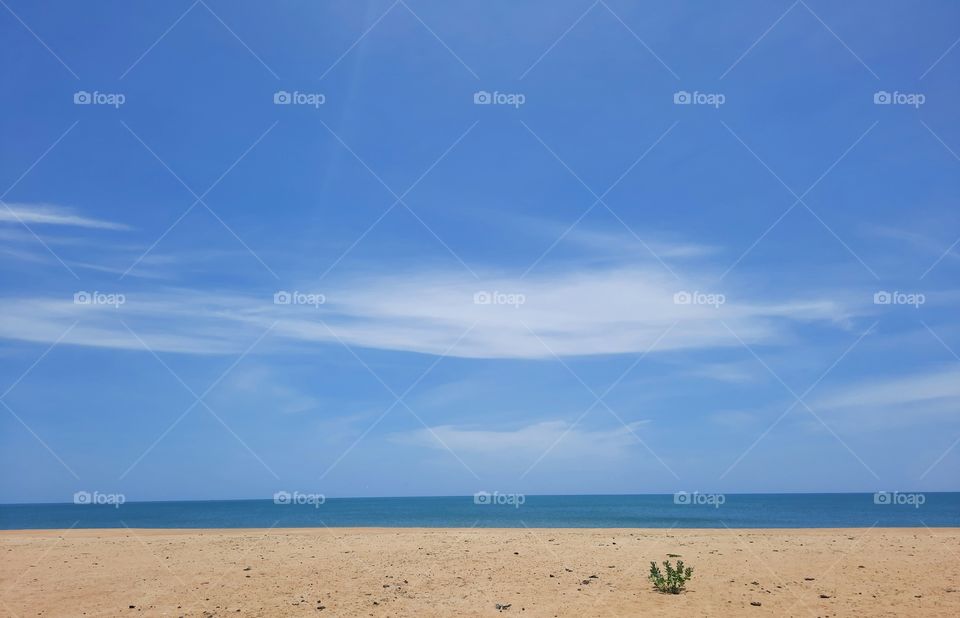 Perfect summer beach on a perfect sunny day with beautiful blue waters and beautiful blue sky. No filters. Nature at its true and best.