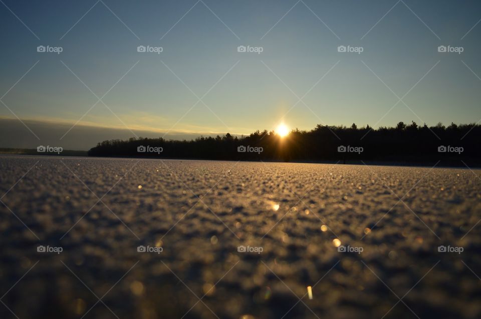 sunrise on winter ice lake