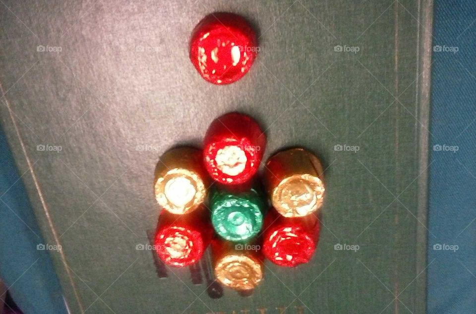 rolos in a decirative arrangements. laid out in a book of Mormon. Christmassy