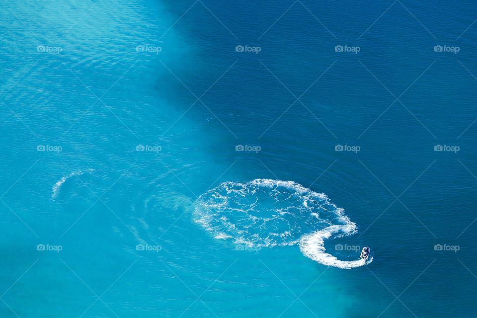 Jetski in blue sea, aerial view