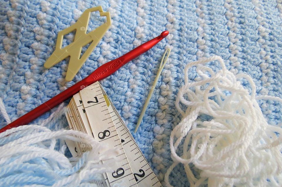 Crocheting a baby blanket.