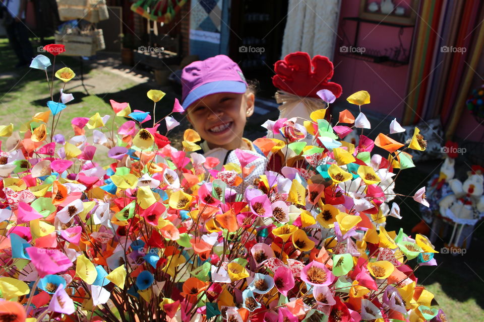 little girl offering a bouquet of colorful fabric flowers to her mother