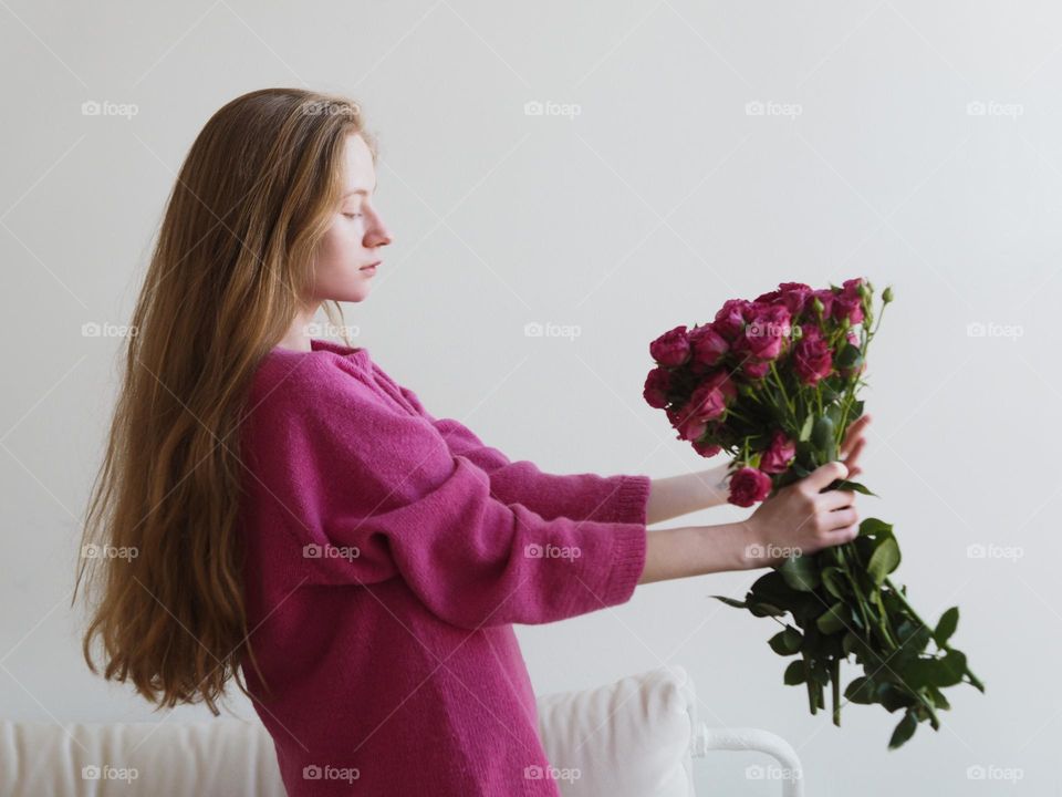 Young beautiful blonde girl with bouquet 