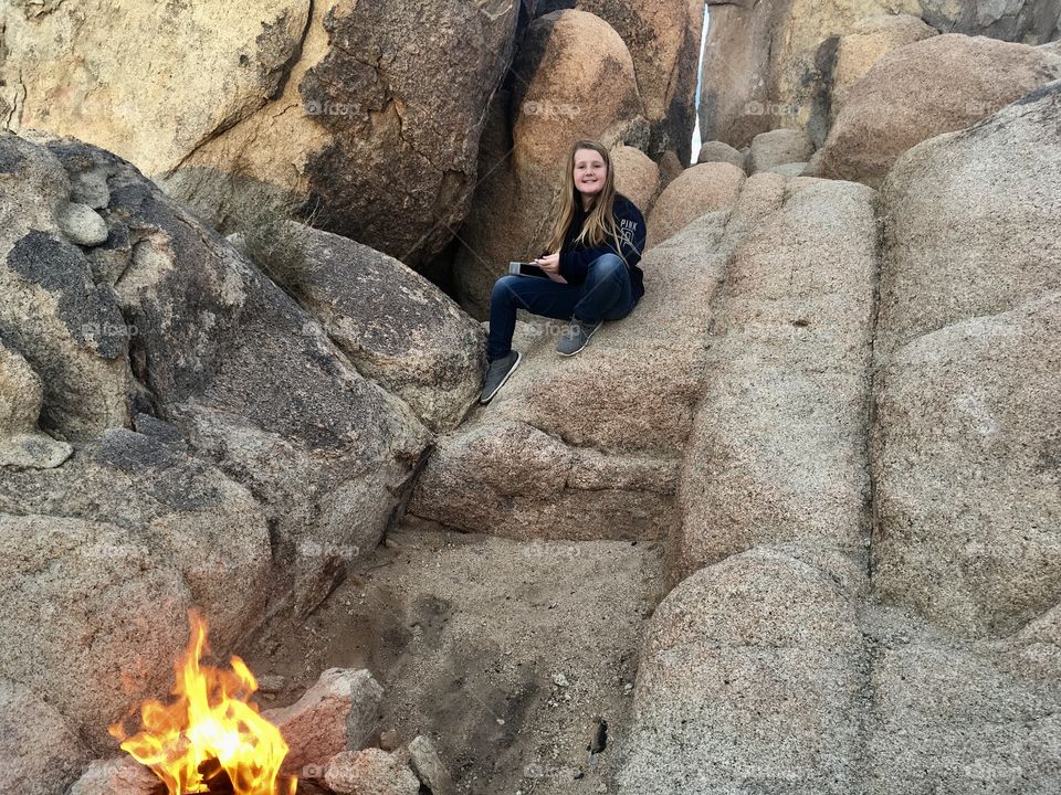 Taking shelter in between the desert rocks above the camp fire 