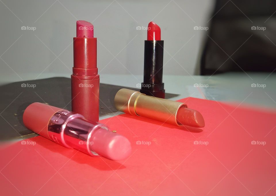 Four different  colour lipsticks photo taken from front