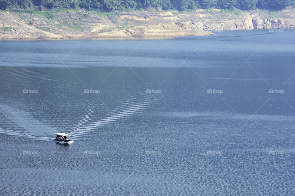 The tourist boat on water at Khun Dan Prakan Chon Dam ,Nakhon Nayok in Thailand