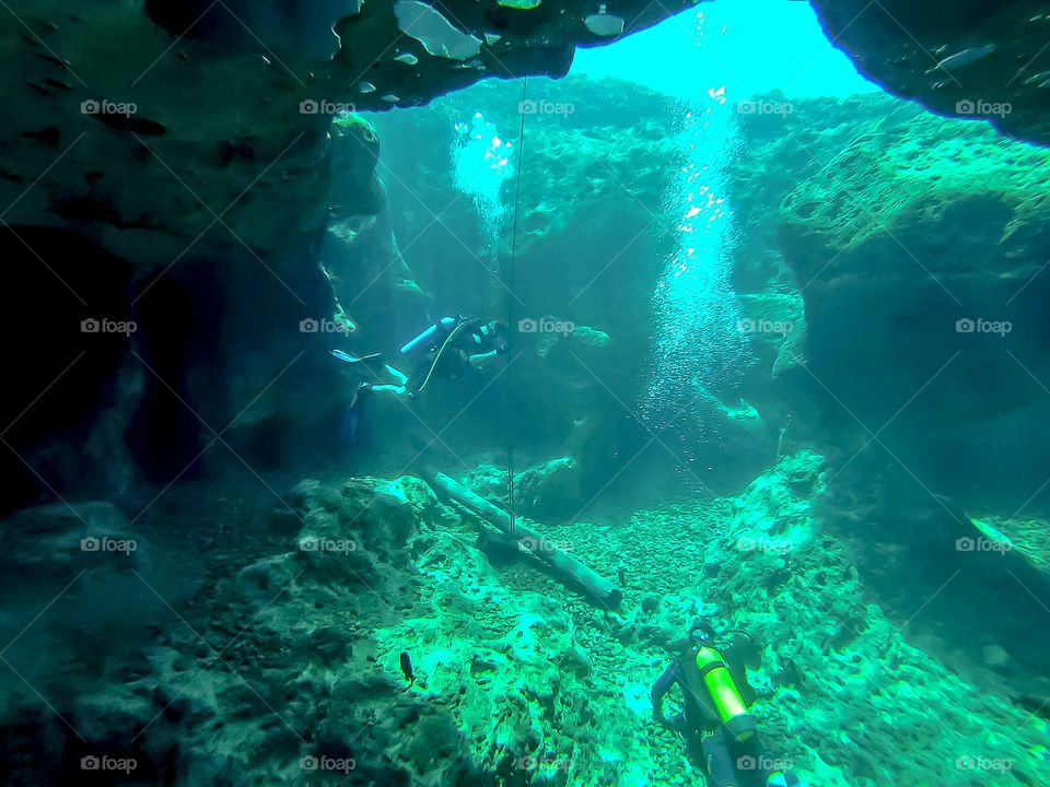 scuba diver cave diving in ocean