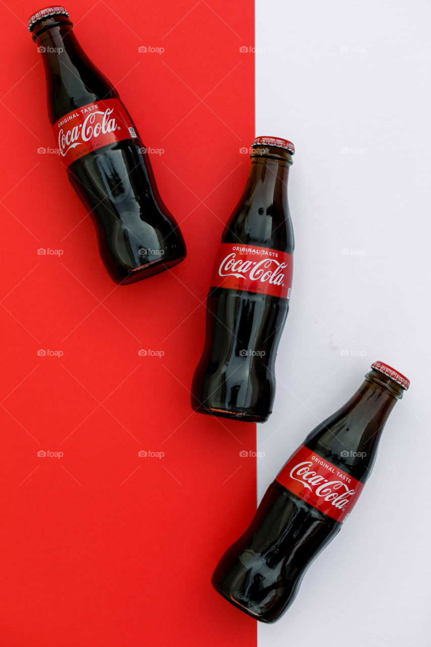 Coke bottles on contrasting background 