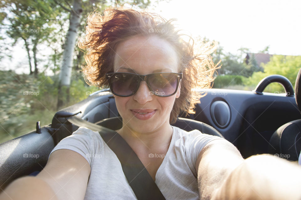 woman in convertible. woman enjoying the ride in a convertible car with roof down