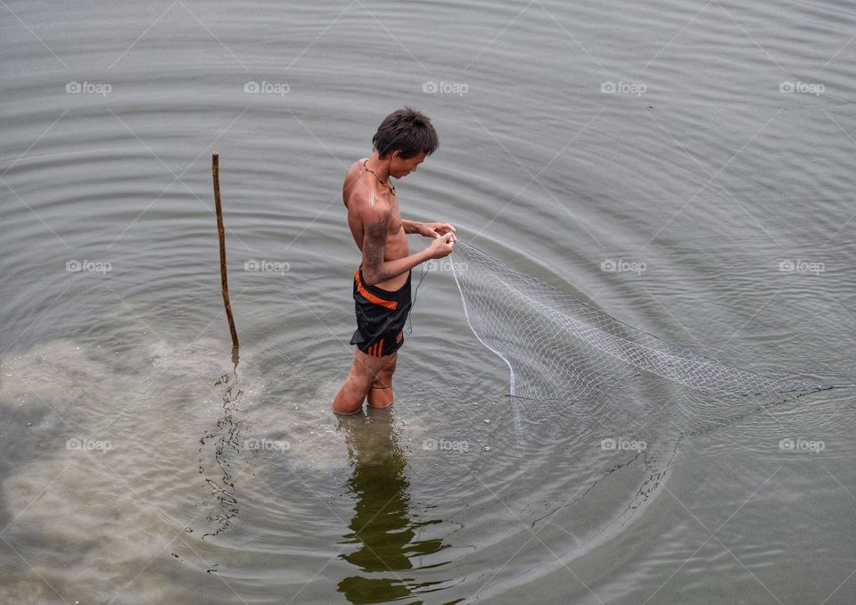 Local life style of fisherman in Early morning at Uben bridge , the longest wooden bridge in the world.