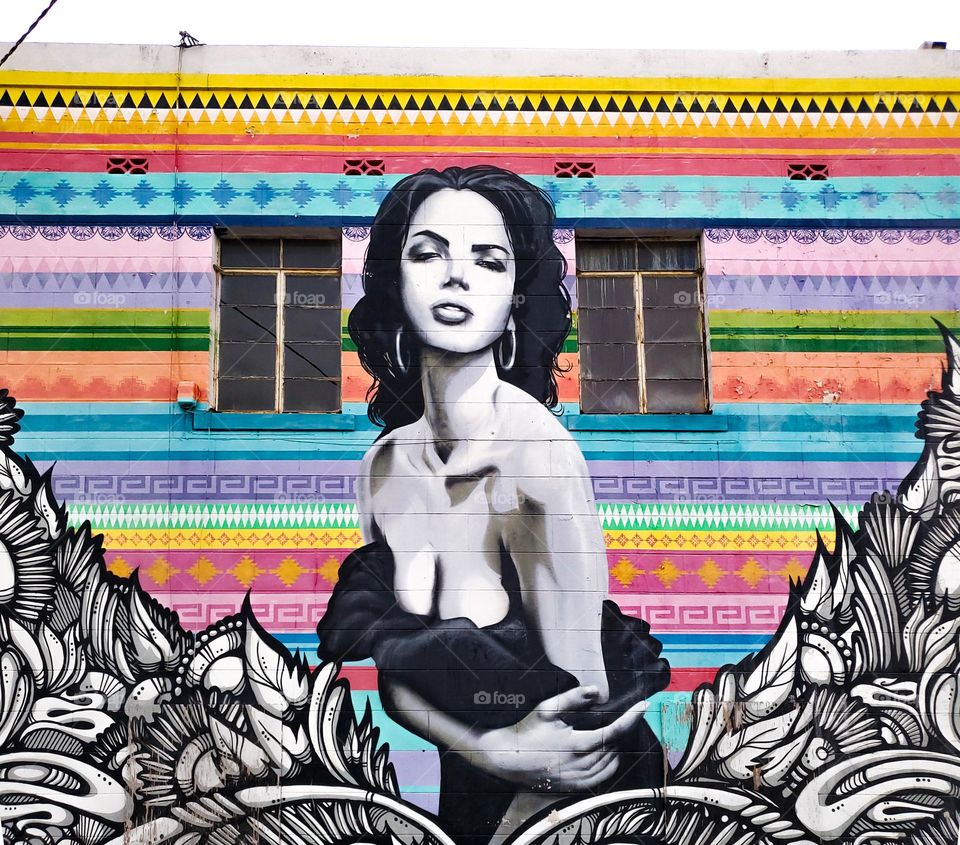 Colorful cultural street art of a beautiful Hispanic woman.