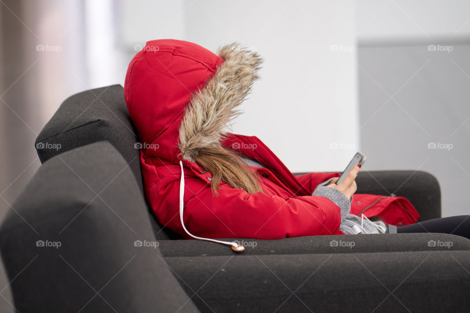 Red woman sitting indoors 