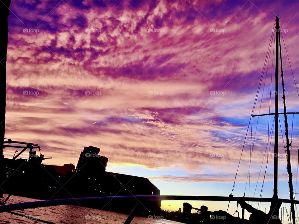 A magnificent view of the evening sky over Newtown Creek in Long Island City at sunset just before nightfall. The clouds above are reflecting the setting sun’s last rays in all nuances of pink, magenta and purple. 2021. Hypnotic Productions