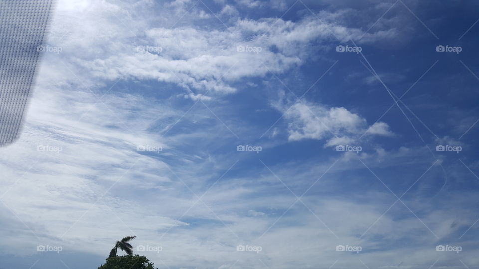 The clouds stretch across an otherwise clear blue sky.