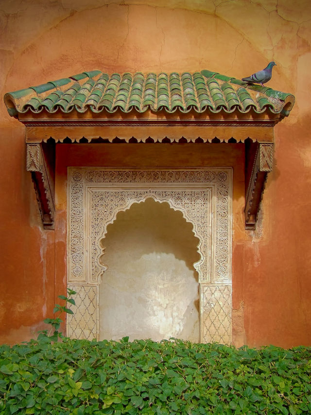 Mysterious gate to nowhere. Decorative feature in earthy colored wall. Marrakesh. Morocco.