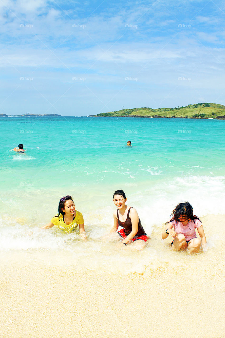 Girls having fun swimming at the beach