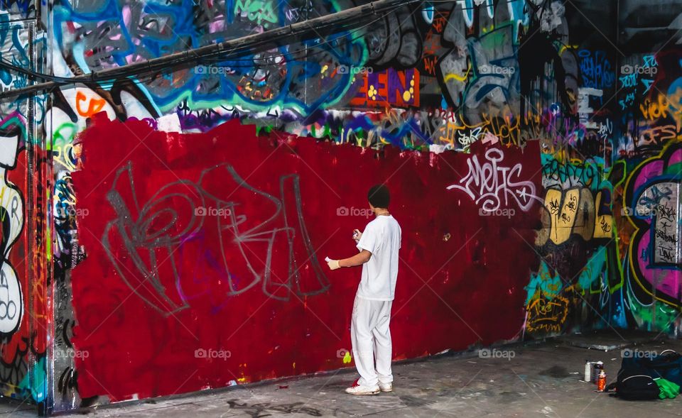 A young street artists prepares a new design at London’s Southbank skater park, 2009
