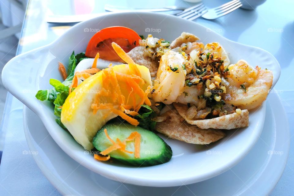 Garlic shrimp with vegetable salad.