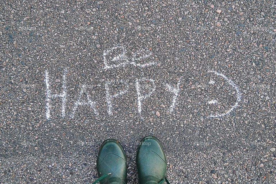 High angle view of text with shoe on road