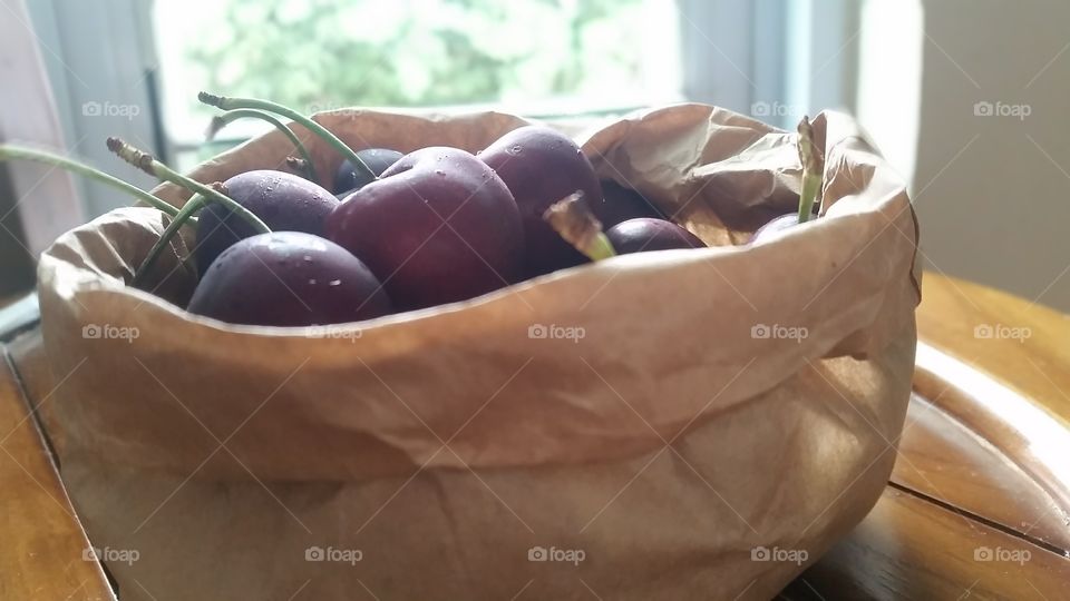 Bagful of goodness. cherries by the window