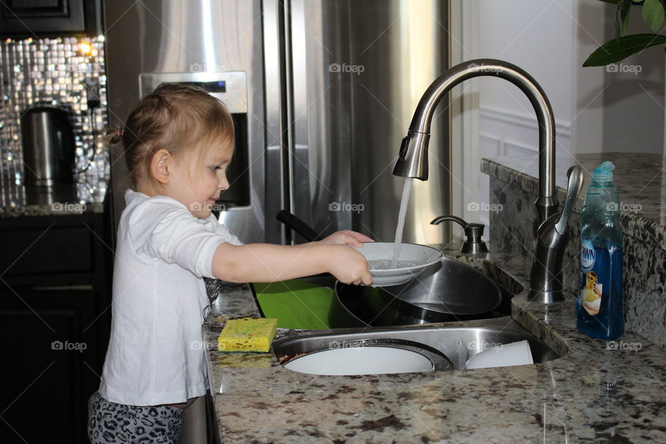 child helping with dishes