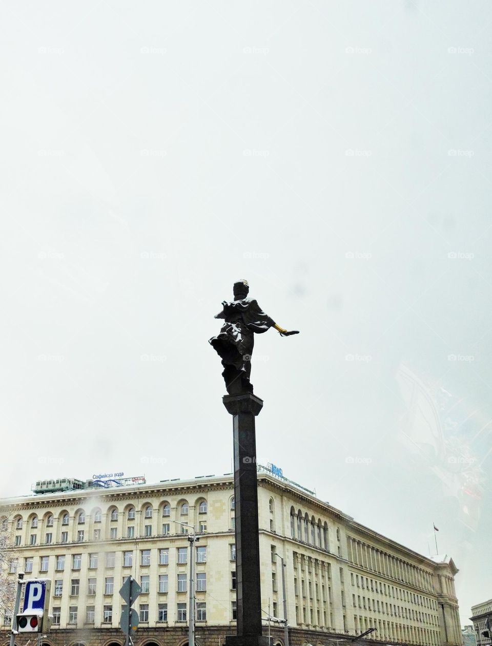 A photo of the famous statue in the centre of the capital city of Bulgaria captured from the back in the rainy weather