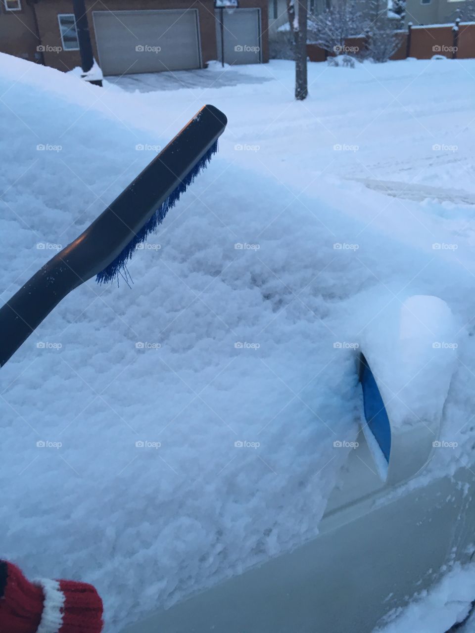Snow covered car. Brushing off my son's snow covered car