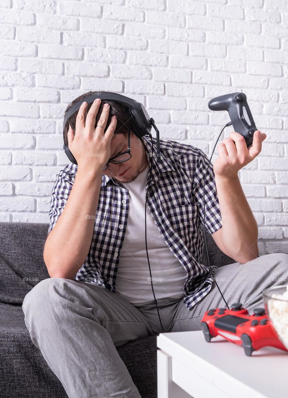 young emotional man playing video games