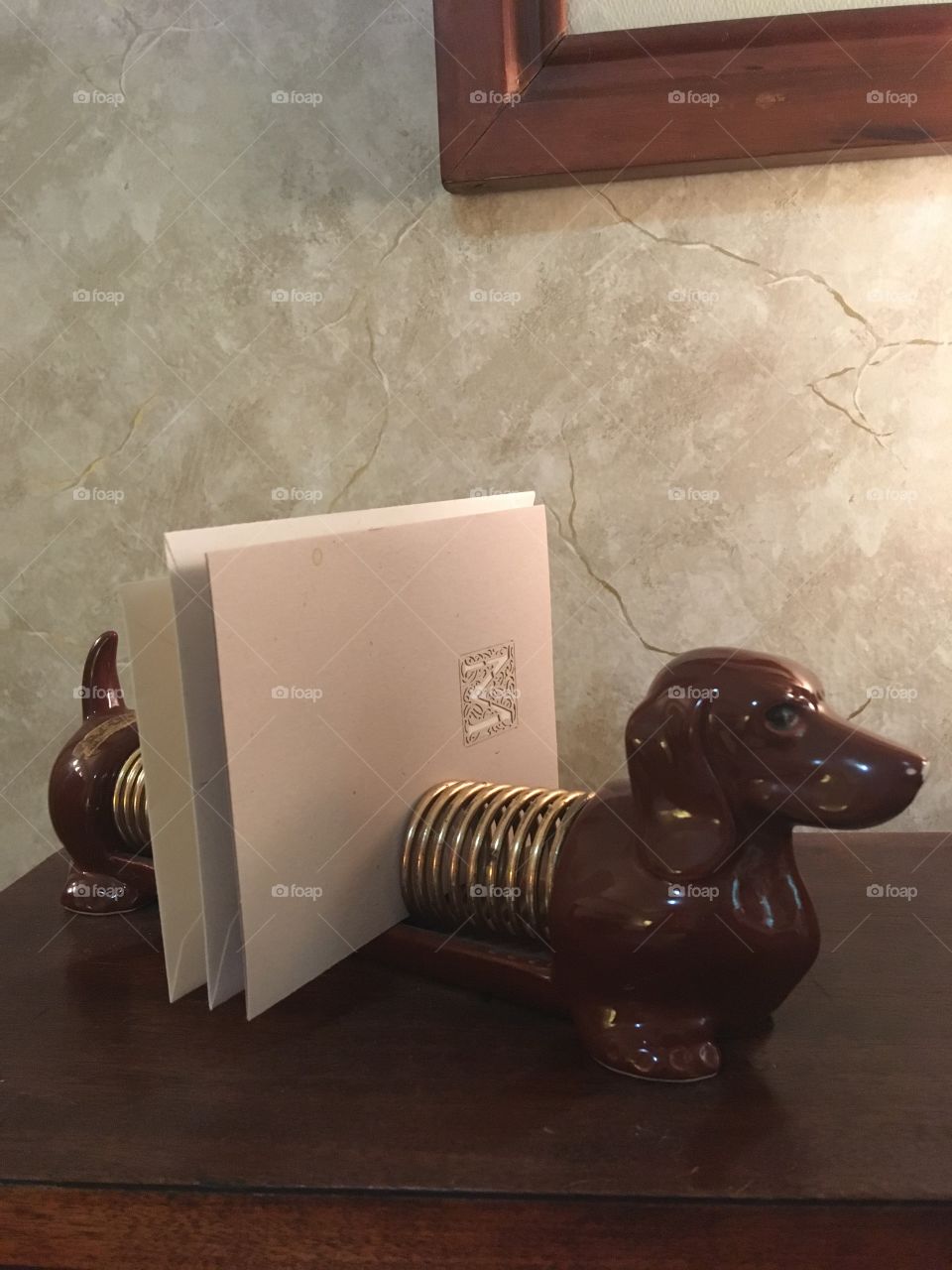 A mid century wiener dog helps keep cards and letters organized on your desktop.