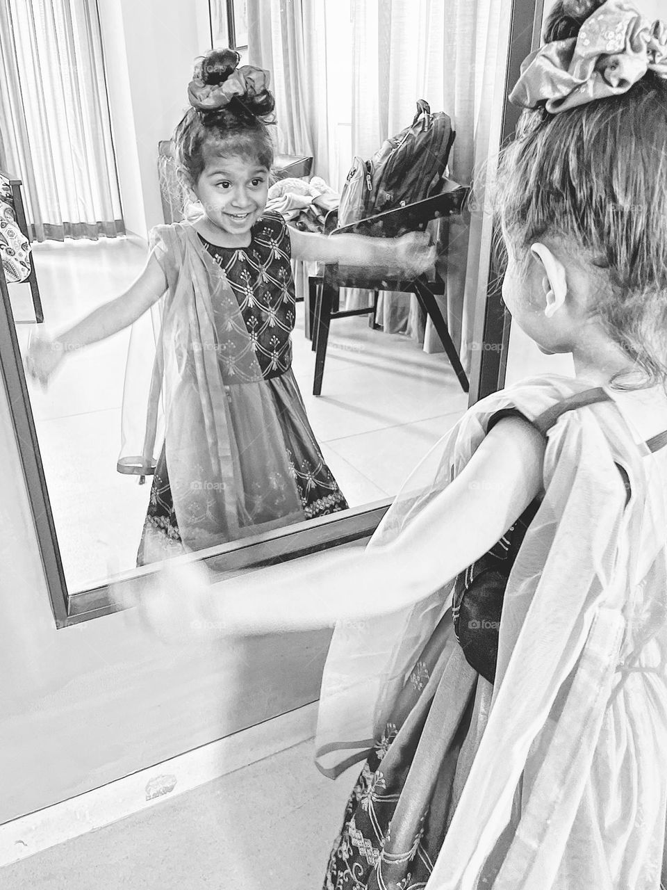 Little girl excited about reflection, toddler looks in the mirror, little girl excited about seeing herself in the mirror, reflection in the mirror 