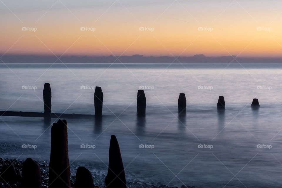 Moments before the sunrises over the English Channel at Winchelsea Beach, UK