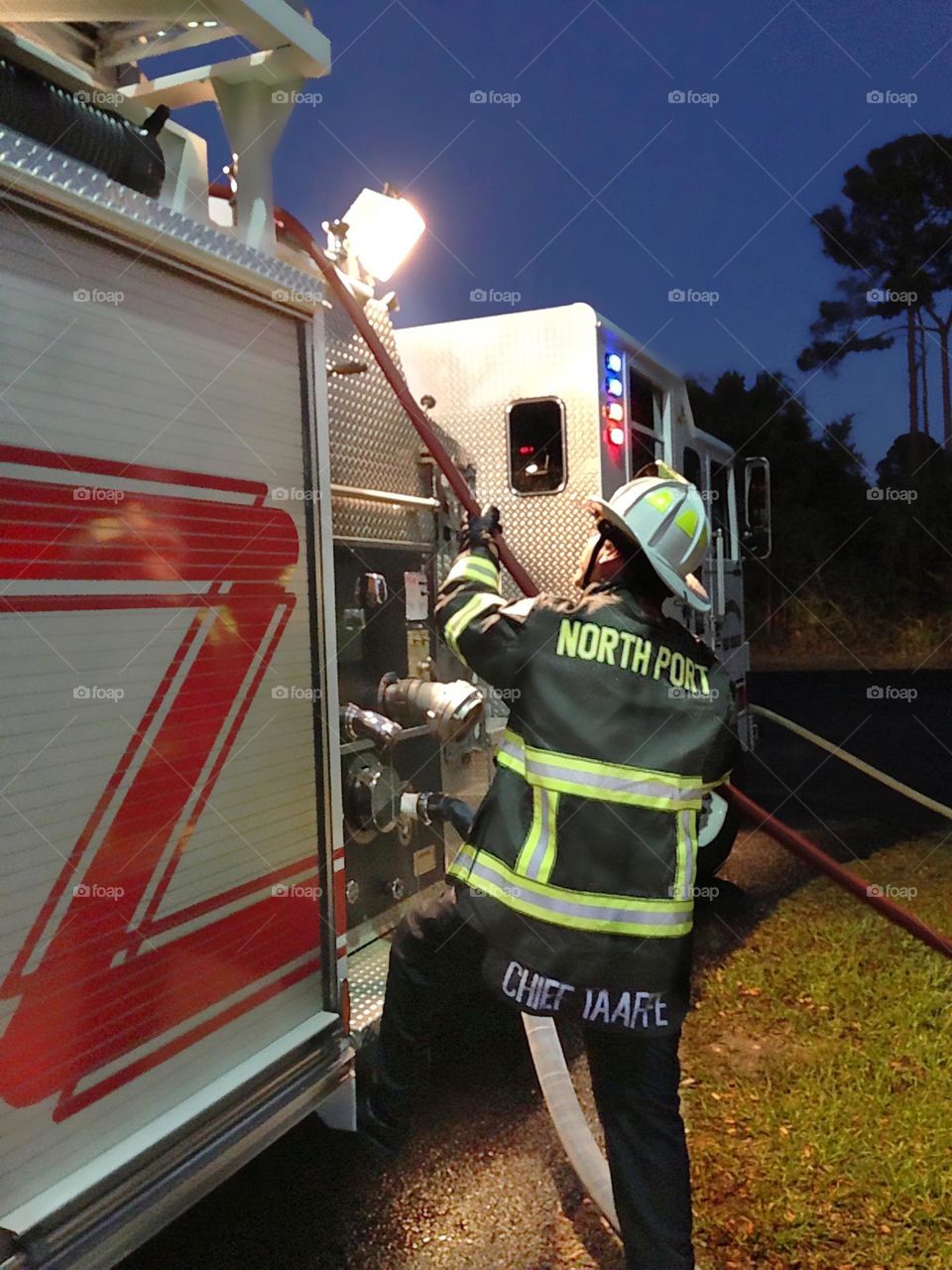 Fireman working hard with his fire engine.