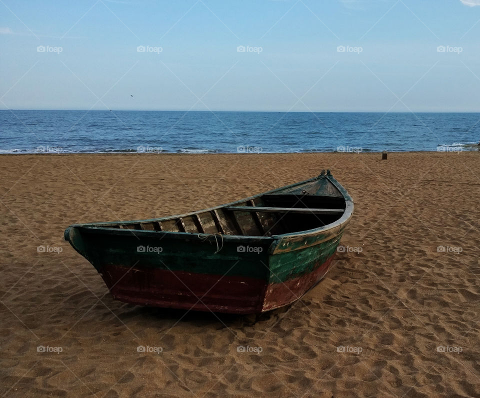 A Sandy Beach with A Single Boat