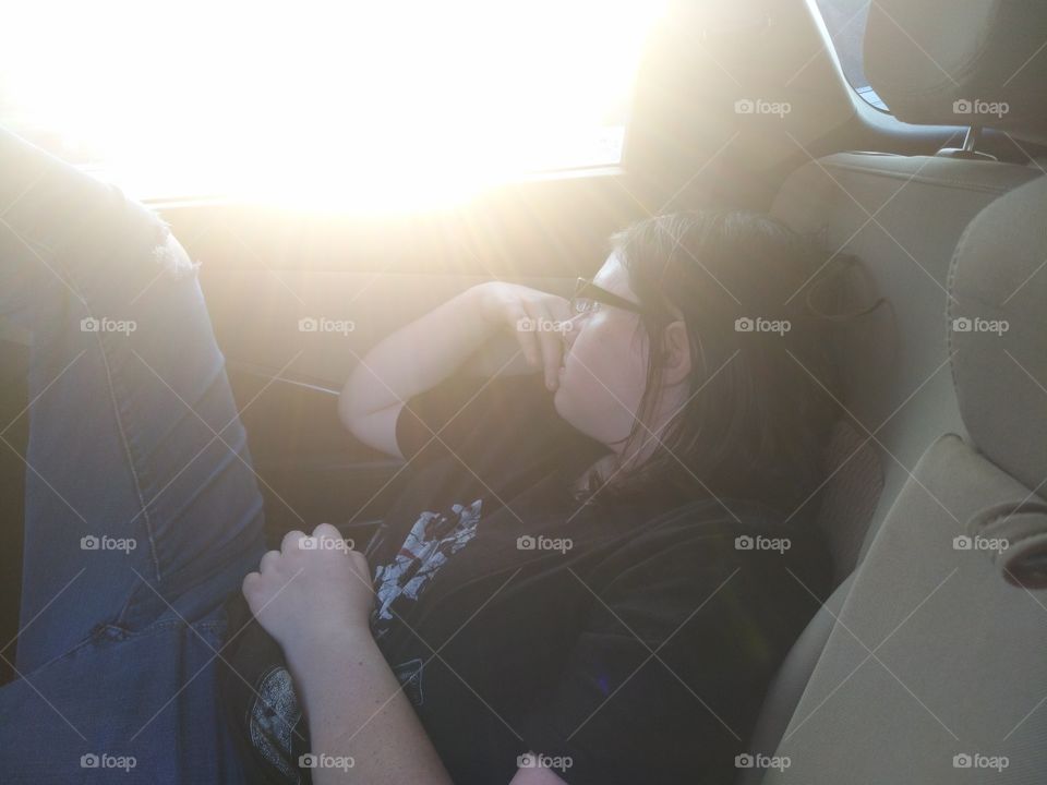 person sitting comfortably in car staring at the sun.