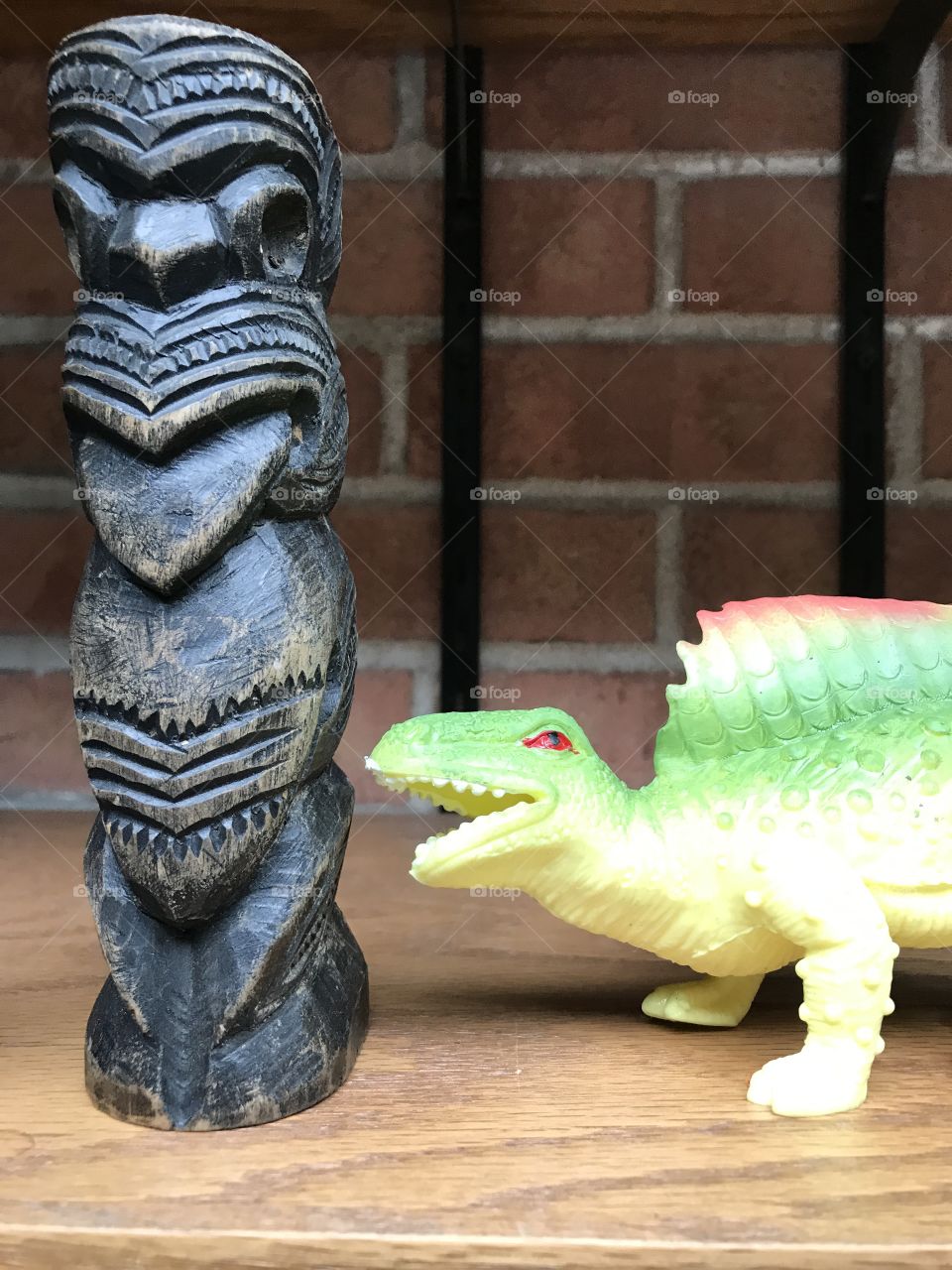 Dinosaur conversation with a Maori tiki